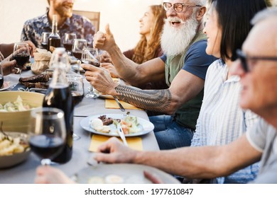 Multi Generational People Having Fun At Barbecue Patio Dinner - Focus On Hipster Man Face