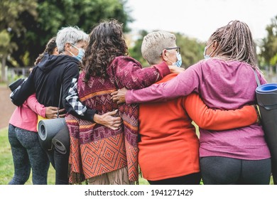 Multi Generational Women Having Fun Before Yoga Class Wearing Safety Masks During Coronavirus Outbreak At Park Outdoor - Sport And Social Distance Concept - Main Focus On Right Female With Grey Hair