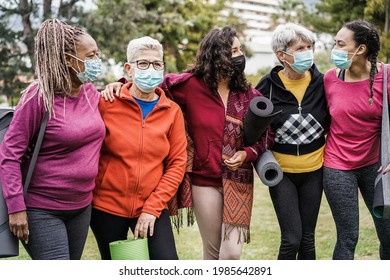 Multi Generational Women Having Fun Before Yoga Class Wearing Safety Masks At Park Outdoor - Main Focus On Center Girl Face