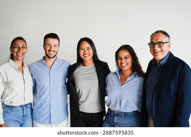 Multi generational workers smiling in front of camera inside business office - Multiracial entrepreneur and teamwork concept - Main focus on asian girl face