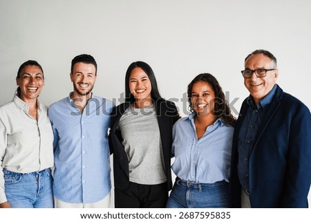 Multi generational workers smiling in front of camera inside business office - Multiracial entrepreneur and teamwork concept - Main focus on asian girl face