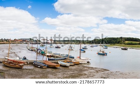 A multi image panorama of the boats on the River Deben in front of Woodbridge Quay seen in Suffolk in July 2022.