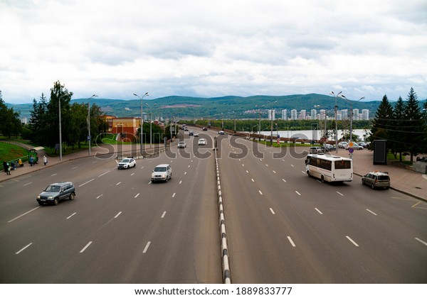 Multi lane road with vehicles. Multi lane road\
with a concrete lane\
divider.
