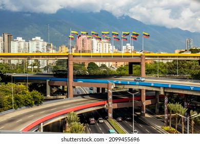 Multi level highway in center of Caracas capital Venezuela with national flags at day