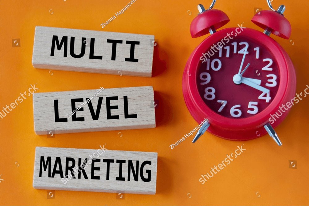 MULTI LEVEL MARKETING - words on wooden blocks on an orange background ...