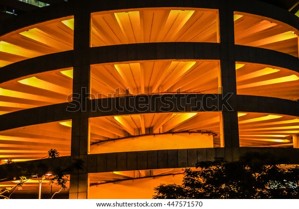 Multi level\
parking car garage in the night. Open car parking with cars at\
night. Example of modern architecture. Multi level garage view\
multi level parking lot for vehicles\
cars