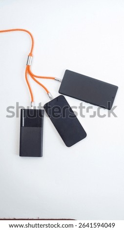A multi purpose charging cable connected to devices isolated on white background