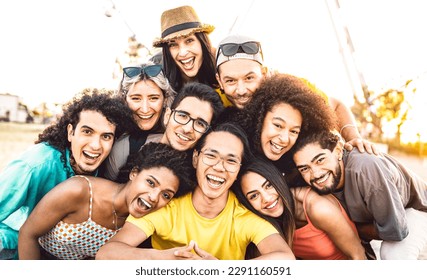 Multi racial diverse friends taking selfie at beach party festival - Happy life style and summer holidays concept on trendy generation people having fun day together out side - Vivid backlight filter - Powered by Shutterstock