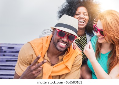 Multi Racial Friends Having Fun Outdoor Laughing And Enjoying A Joke. Cheerful Young People With Carefree Happy Expressions. Concept Of Diversity And Friendship