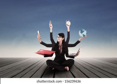 Multi tasking Asian businesswoman  - Powered by Shutterstock