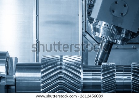 The multi tasking CNC lathe machine gear cutting on the metal shaft part with indexable tool in the light blue scene. The turn-mill machine cutting the high automotive parts control by CNC program.
