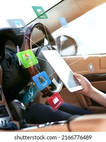 Multi Tasking In The Drivers Seat. Shot Of A Driver Holding A Digital Tablet Surrounded By Icons.