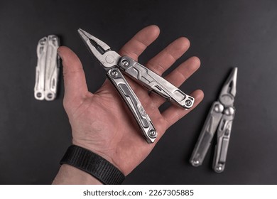 Multi -tool in the hand on a black background