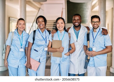 Multi0ethnic group of happy medical and nursing students standing in a hallway at medical university and looking at camera.  - Powered by Shutterstock