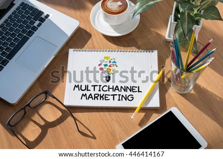 MULTICHANNEL MARKETING open book on table and coffee Business