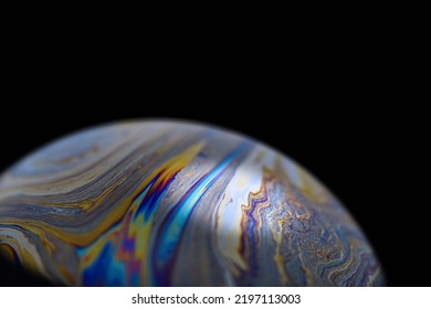 Multicolor abstract cold alien planet with an atmosphere in universe. Closeup soap bubble