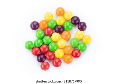 The multicolor flavored fruit candies on white background. Top view.