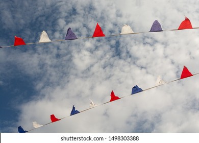 Multicolor Pennant Banner, Triangle Festival Flags, Decoration For Outdoor Event, Open Air Party, Backyard Picnic. Decorative Flags With Cloudy Sky On Background