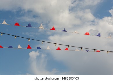 Multicolor Pennant Banner, Triangle Festival Flags, Decoration For Outdoor Event, Open Air Party, Backyard Picnic. Decorative Flags With Cloudy Sky On Background