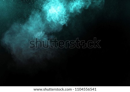Multicolor powder explosion on black background. Colored cloud. Colorful dust explode.