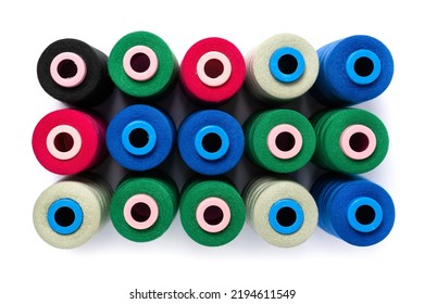Multicolor sewing threads, thread spools. Sewing tools and sewing accessories. Top view, flat lay for tailor