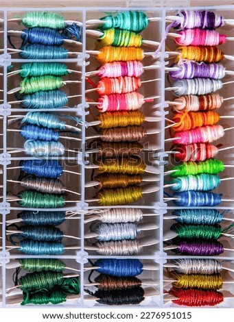 Multicolor threads for embroidery cross-stitch, mulina. Color background.
