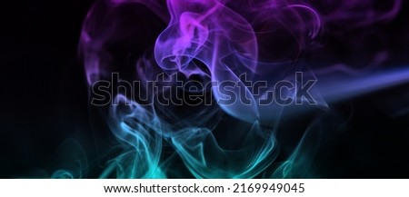 Multicolored abstract smoke for relaxation, close up black background, beautiful swirled clouds of smoke. Pink, purple and turquoise gradient colors of dense smoke, multi colour smoke curls