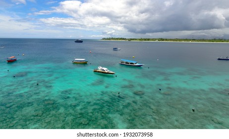 Multicolored boats in the distance on the island. Caribbean ocean gili trawangan : Lombok Indonesia 9 March 2021