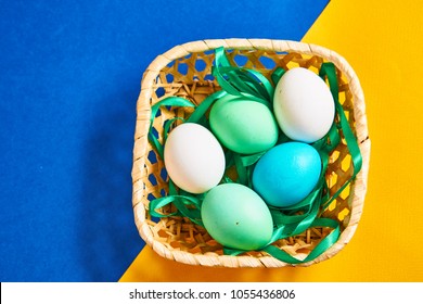 multi-colored boiled eggs in a basket, greens, miscellaneous background...