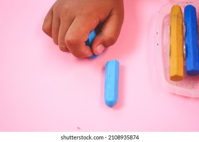 Multicolored broken crayon on pink background - Powered by Shutterstock