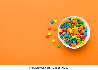 Multicolored candies in a bowl on a colored background. birthday and holiday concept. Top view with copy space. - Powered by Shutterstock