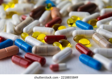 Multicolored capsules lie on a white background. Medical preparations, nutritional supplements, biologically active food additives, vitamins, minerals, probiotics. Dietetics, sports nutrition, health. - Shutterstock ID 2218855849