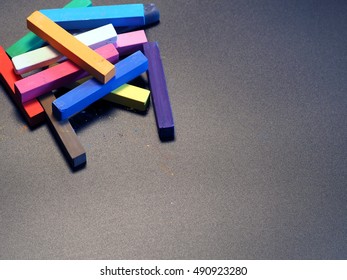 multicolored chalks on a dark background
