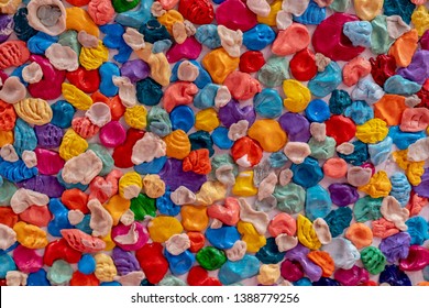 A lot of multi-colored chewing gums pasted on the wall creates a uniform texture - Powered by Shutterstock