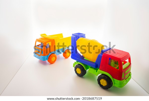 Multicolored children\'s toy plastic toy truck, dump\
truck on a white background z for children\'s games on a white\
background, place for\
text