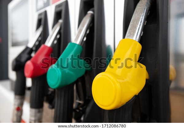 multi-colored clean pistols at a gas station with\
fuel for cars