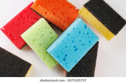 A multi-colored cleaning sponge scattered across the surface. Multi-colored household sponge. - Powered by Shutterstock