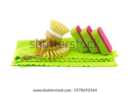 Multicolored cleaning sponges and dish brushes on microfiber cloth isolated on a white background. House cleaning products
