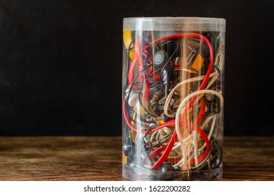 Multi-colored Computer Cables, Earphones, Wires, Chargers In A Lastikom Bank. A Set Of Various Used Wires For Recycling. Side View. Eye Level Shooting. Selective Focus.