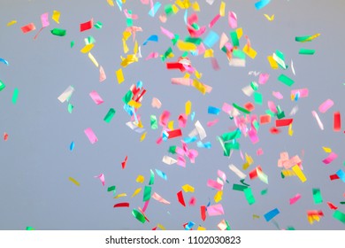 multicolored confetti on a grey background. Concept of holiday backdrop - Shutterstock ID 1102030823