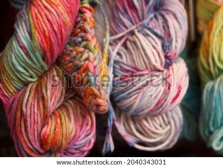 Multicolored cotton yarn for knitting. Hand-dyed threads. Modern tie dye on the thread skein. Craft and hobby motley background