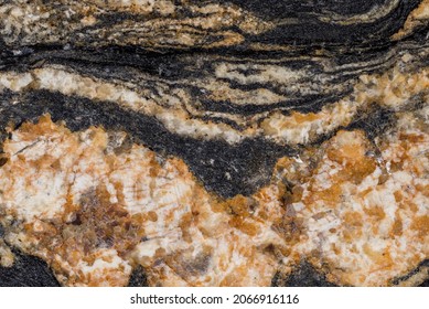 Multicolored Crystalline Texture Of Polished Granite Slab. Granite Rock Made Of Coarse-grained Interlocking Crystals