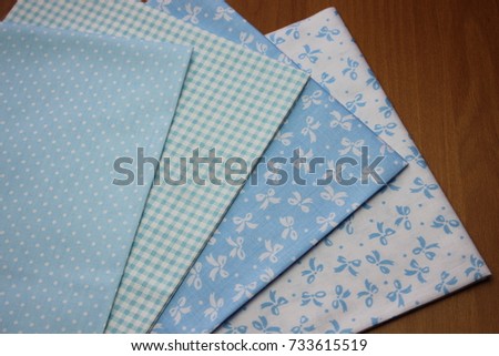 Multicolored cuts of fabric against the background of boards