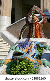 Multicolored dragon with ornamental brown tripod at Guell park, Barcelona, Spain