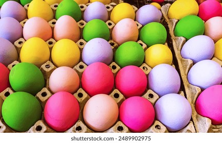 Multicolored easter eggs in egg tray. Creative Easter concept. Colorful handmade Easter eggs in paper container. Multicolored eggs in a cardboard egg carton. Egg in recycled basket protein breakfast. - Powered by Shutterstock