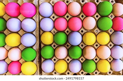 Multicolored easter eggs in egg tray. Creative Easter concept. Colorful handmade Easter eggs in paper container. Multicolored eggs in a cardboard egg carton. Egg in recycled basket protein breakfast. - Powered by Shutterstock