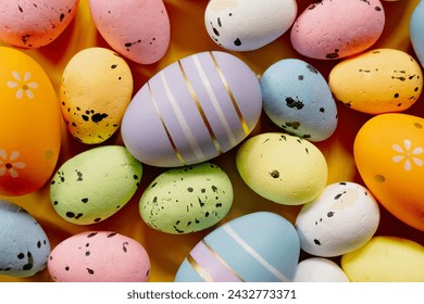 Multi-colored Easter eggs on a yellow spring background. Happy easter.