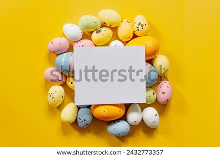 Multi-colored Easter eggs on a yellow spring background. Happy easter.