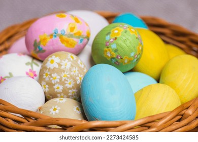 Multicolored Easter eggs in a wicker basket. Pastel colors of Easter eggs, background. - Shutterstock ID 2273424585