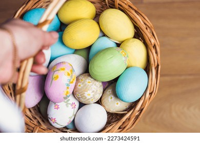 Multicolored Easter eggs in a wicker basket. Pastel colors of Easter eggs, background. - Shutterstock ID 2273424591